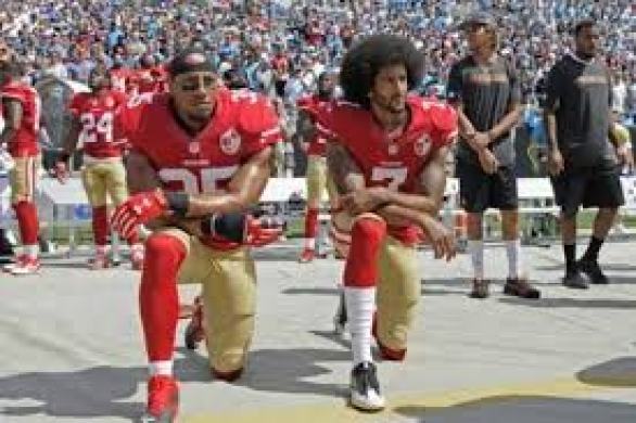 Colin Kaepernick and teammate Eric Reid (left) take a kneel during the national anthem to protest the unarmed killings of Black people by the police. As of Aug. 10, Kaepernick remains unsigned.